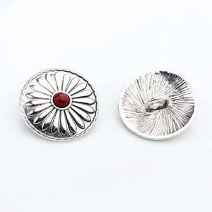 Macro detail of retro sunflower metal buttons with red resin stone inlay and shank back