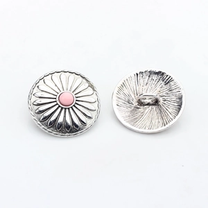 Detailed front and back view of vintage silver sunflower button with pink center bead