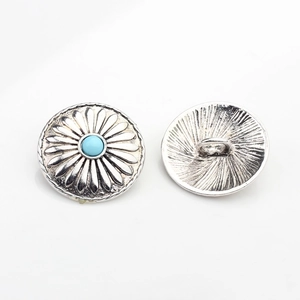Detail of silver alloy sun flower button with blue stone inlay and sewing loop