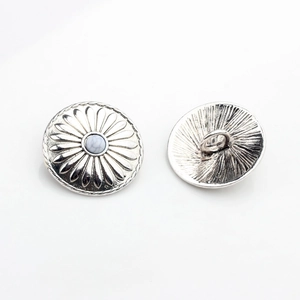Detail of vintage silver sunflower shank buttons with white stone inlay for DIY crafts