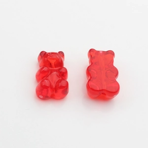 Detailed close-up of red gummy bear resin pendants for DIY jewelry making and crafts