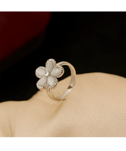 Macro detail of silver flower ring with cat eye stone petals and micro-pave zircons