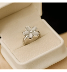 Macro shot of opal flower ring with sparkling crystals in a velvet jewelry box