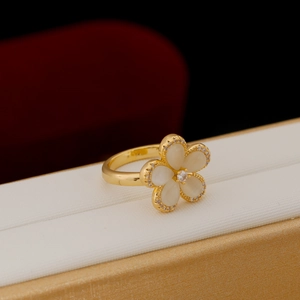 Elegant gold flower ring featuring cat eye petals and sparkling crystal accents on a box