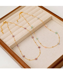 Detail of colorful beaded flower necklaces in gold plating on a premium jewelry display box