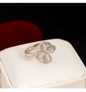Close-up of silver clover ring with cat-eye stone petals and sparkling zircon accents