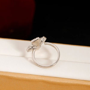 Silver four-leaf flower ring with white mother of pearl inlay and beaded edges