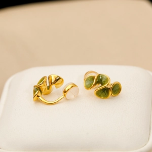 Chic gold leaf-shaped clip-on earrings with green enamel and white pearl details