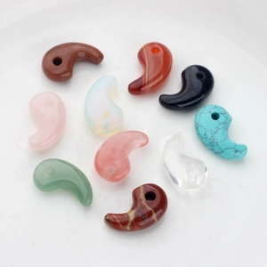 Mix of Yin Yang comma-shaped natural stone pendants including rose quartz and aventurine