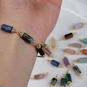 Detail view of 14K gold-plated 7-chakra natural stone cylinder beads for DIY jewelry making
