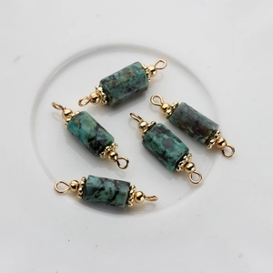 Close-up of 5-piece 14K gold plated natural stone cylinder charms for DIY jewelry