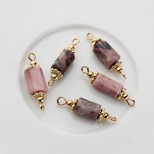 Macro detail of 14K gold-plated double-loop natural stone pendants with marble texture
