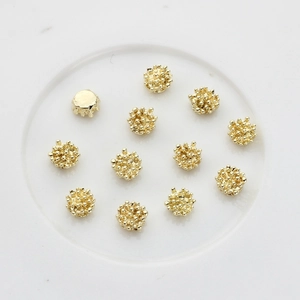 Golden spherical flower stamen alloy charms for DIY jewelry making on white tray