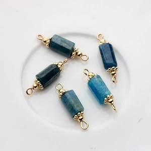 Macro detail of 14K gold plated connectors with rectangular blue natural stone pendants