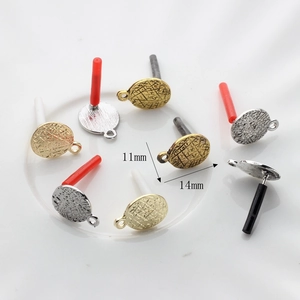 Detailed view of textured oval earring posts in gold and silver for DIY jewelry making