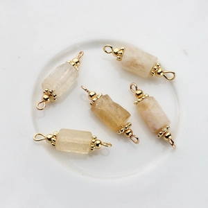 Macro detail of 14K gold-plated connectors with natural yellow stones for DIY jewelry