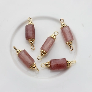 Detailed view of pink strawberry quartz columns with gold metal loops for DIY jewelry