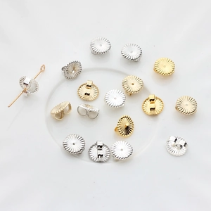 Detailed view of 14K gold filled flower earring backs with radial texture and butterfly clutch