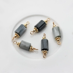 Macro shot of 14K gold-plated marble bead pendants for DIY high-end jewelry crafting