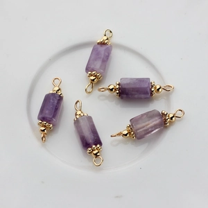 Macro detail of five 14K gold plated natural purple stone pendants for DIY jewelry making