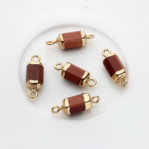 Detail of five gold-plated hexagonal stone connectors with dual rings for DIY jewelry