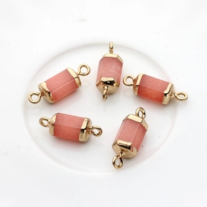 Detailed view of five hexagonal rose quartz pendants with gold caps and double bails