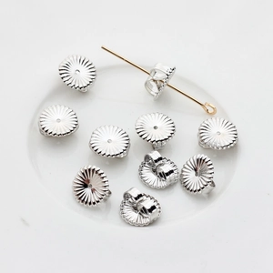 Macro detail of silver flower petal earring backs and post closure for DIY jewelry