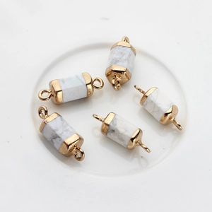 Detail of five hexagonal natural stone connectors with gold plated caps and double loops