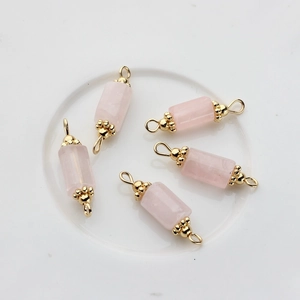 Detailed view of 14K gold plated natural rose quartz cylinder pendants with double loops