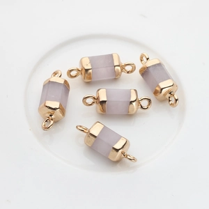 Detailed view of light purple stone cylinder charms with gold plated connectors for DIY jewelry