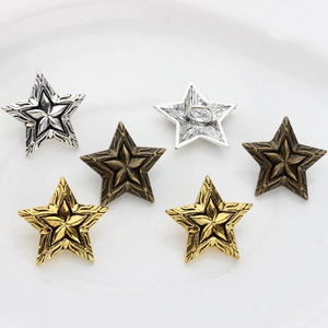 Detailed macro of vintage star-shaped alloy buttons in silver, bronze, and gold finishes