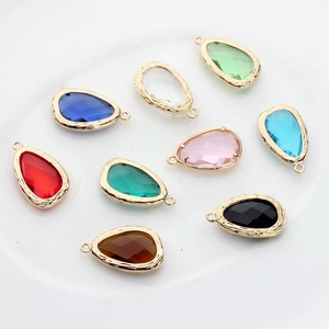 Detailed view of nine colorful teardrop glass pendants with textured 14K gold plated borders