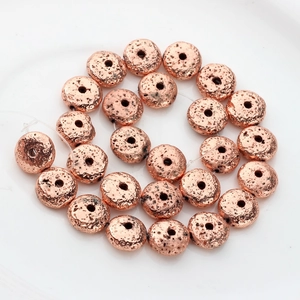 Macro view of rose gold electroplated lava rock beads with porous texture for DIY jewelry