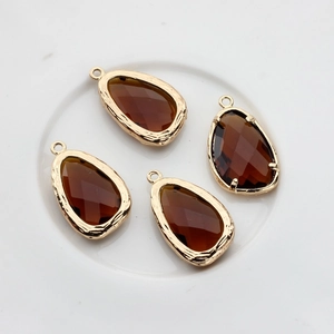 Close-up of four brown faceted glass teardrop pendants with 14K gold-filled metal frames