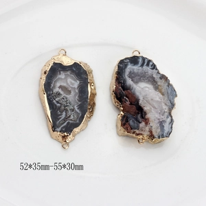 Macro view of irregular natural agate geode slice pendants with gold plated edges