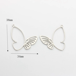 Detailed view of silver butterfly wing charms with size specs 38mm x 34mm for DIY jewelry