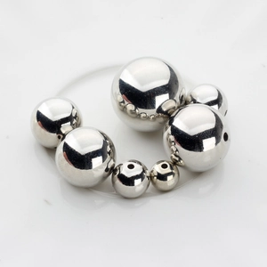 Macro view of mirror-polished silver spacer beads in various sizes for DIY jewelry making