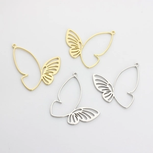 Detailed view of hollow butterfly charms in gold and silver for DIY jewelry making