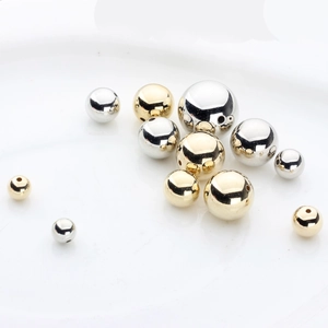 Macro detail of gold and silver metallic spacer beads for DIY jewelry making
