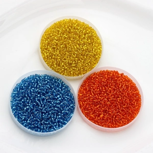 Mix of 2mm silver-lined glass seed beads in yellow, blue, and orange for DIY jewelry making