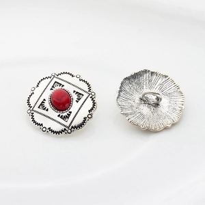 Detail of vintage silver alloy floral buttons with red oval faux stone and back loop
