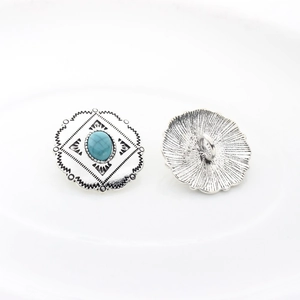 Detail of vintage silver alloy buttons with turquoise stone and ethnic floral patterns