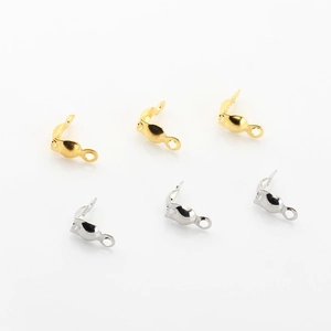 Macro shot of gold and silver bead tips for DIY jewelry making on white background