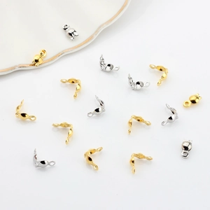 Detailed close-up of gold and silver plated clam shell bead tips for jewelry making