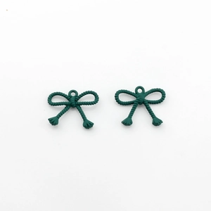 Close-up of dark green bow charms with rope texture for DIY jewelry making