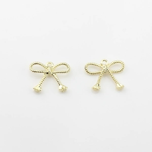 Detailed close-up of golden alloy bow pendants with rope texture for DIY jewelry making