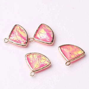 Detail showing four fan-shaped pink and gold crystal pendants with alloy frames and top loops