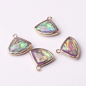 Detailed view of four purple fan-shaped crystal pendants with golden metal frames for DIY jewelry