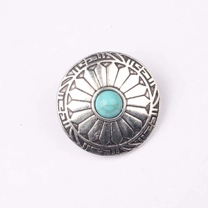 Detailed view of vintage zinc alloy button with turquoise stone inlay for DIY crafts