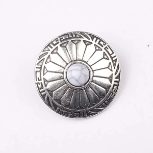 Close-up of vintage zinc alloy flower button with white turquoise stone inlay